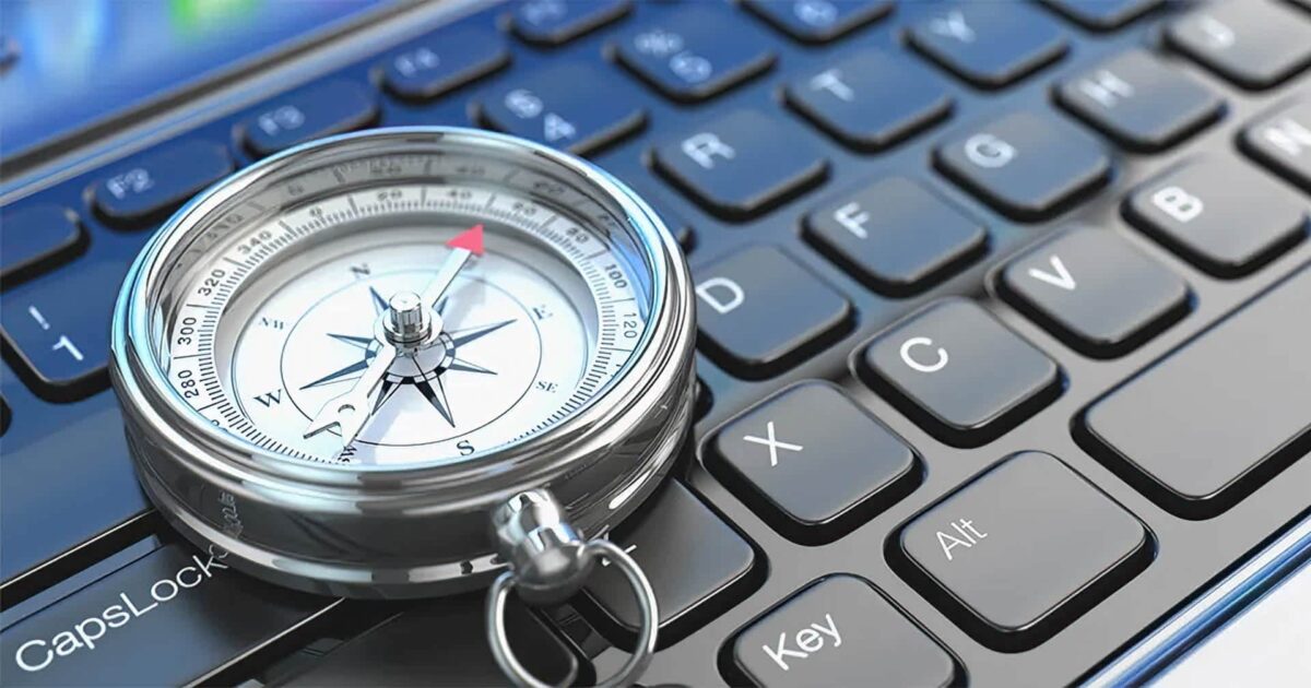 Expert business tech support – silver compass on a black computer keyboard symbolizing clear IT guidance for small businesses