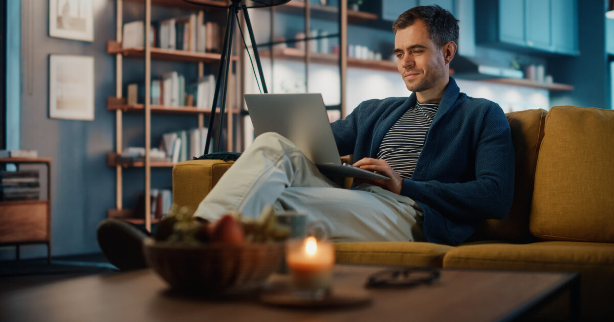 Remote employee working securely on a laptop from a home office as part of a hybrid work setup for NYC small businesses.