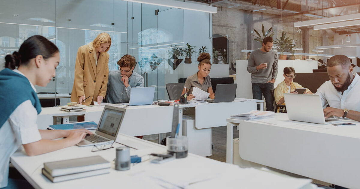 Microsoft Office 365 migration services in NYC office with team members working on laptops and planning a cloud transition