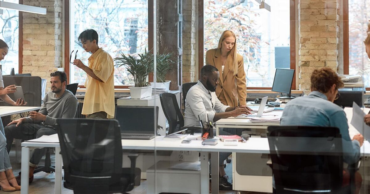 Small business staff reviewing devices and documents during Office 365 migration planning in New York City