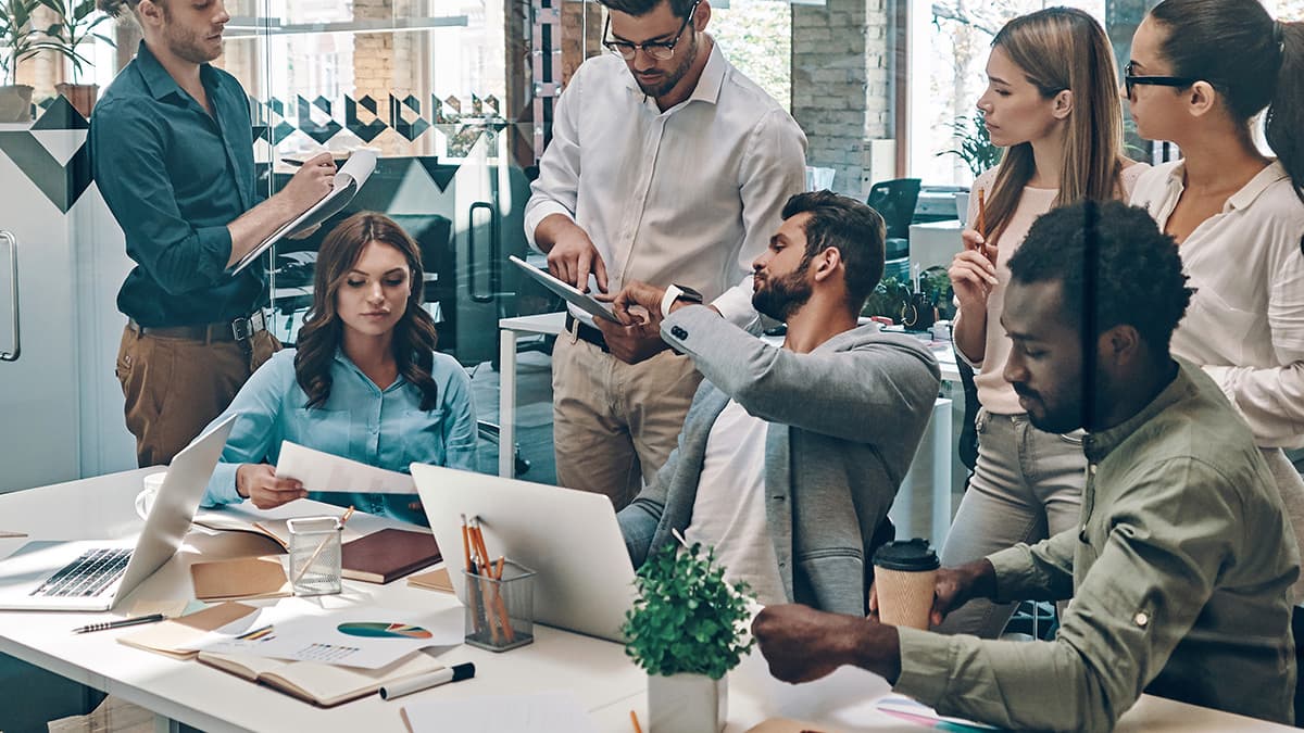 Business team reviewing accounts, files, and device setup before a Microsoft Office 365 migration.