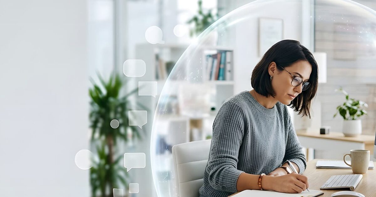 Small business employee working at a computer inside a digital security shield after a Microsoft 365 migration.