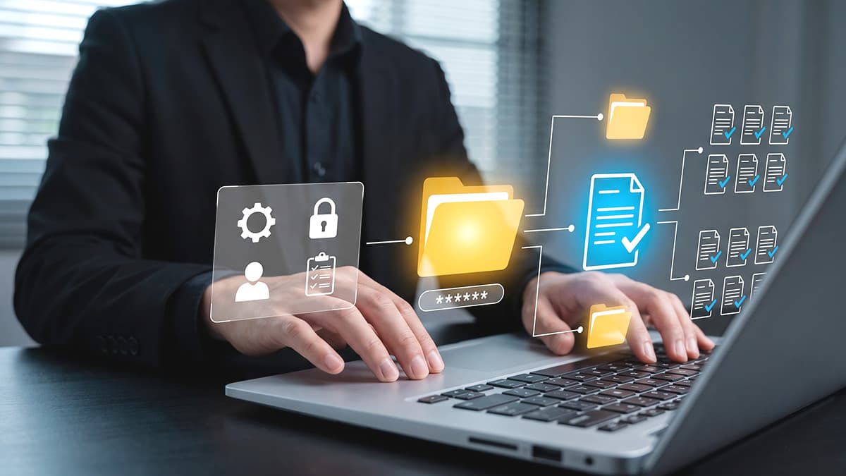 Person using a laptop with folder, document, and security icons illustrating Microsoft 365 data migration.